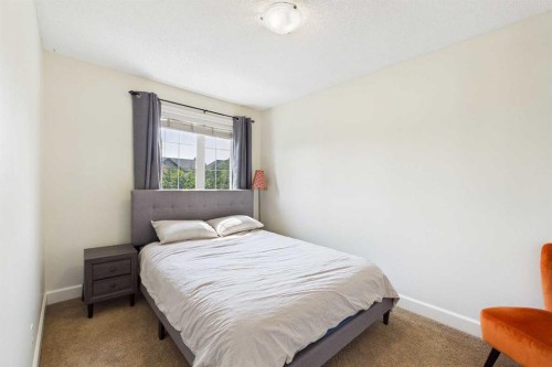 936 Windsong Drive Sw, Airdrie, AB - Indoor Photo Showing Bedroom