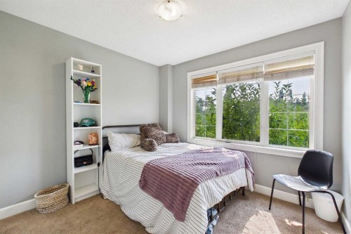 936 Windsong Drive Sw, Airdrie, AB - Indoor Photo Showing Bedroom