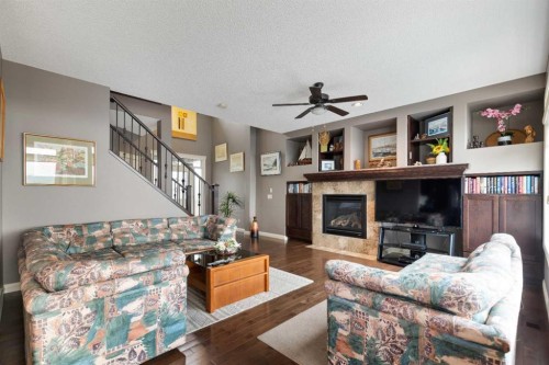 159 Sunset View, Cochrane, AB - Indoor Photo Showing Living Room With Fireplace