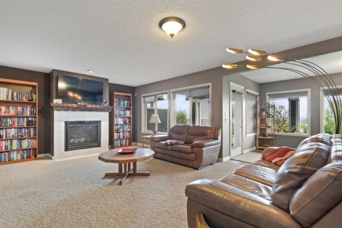 159 Sunset View, Cochrane, AB - Indoor Photo Showing Living Room With Fireplace