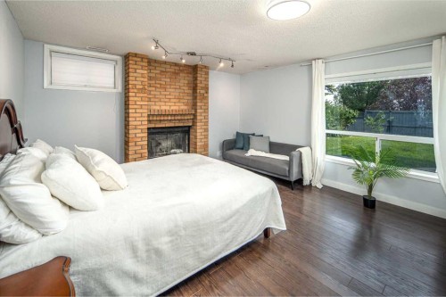 2612 Signal Hill Drive Sw, Calgary, AB - Indoor Photo Showing Bedroom With Fireplace