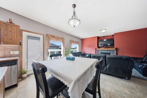 154 Saddleland Close Ne, Calgary, AB - Indoor Photo Showing Dining Room With Fireplace