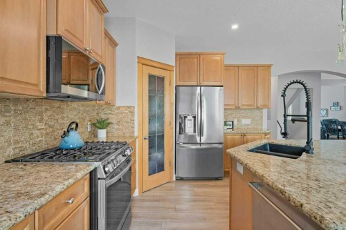 100 Drake Landing Common, Okotoks, AB - Indoor Photo Showing Kitchen With Stainless Steel Kitchen With Double Sink With Upgraded Kitchen