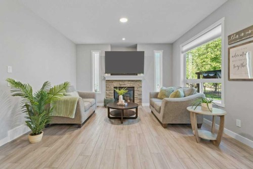 100 Drake Landing Common, Okotoks, AB - Indoor Photo Showing Living Room With Fireplace