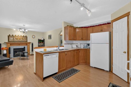 45 Arbour Crest Terrace Nw, Calgary, AB - Indoor Photo Showing Kitchen With Fireplace With Double Sink