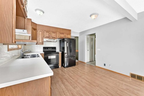 128 Erin Woods Drive Se, Calgary, AB - Indoor Photo Showing Kitchen With Double Sink