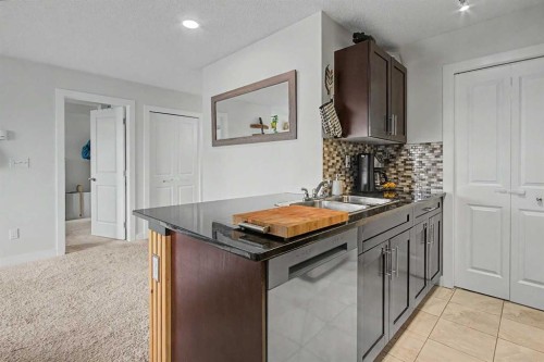 3407-403 Mackenzie Way Sw, Airdrie, AB - Indoor Photo Showing Kitchen With Double Sink