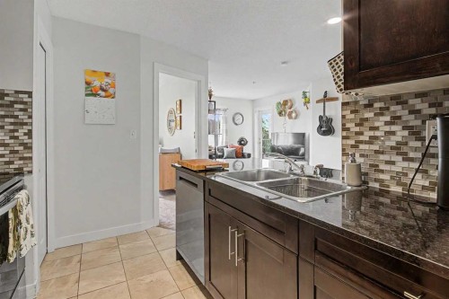 3407-403 Mackenzie Way Sw, Airdrie, AB - Indoor Photo Showing Kitchen With Double Sink