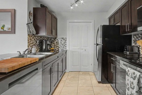 3407-403 Mackenzie Way Sw, Airdrie, AB - Indoor Photo Showing Kitchen With Stainless Steel Kitchen With Double Sink