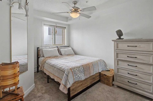 3407-403 Mackenzie Way Sw, Airdrie, AB - Indoor Photo Showing Bedroom