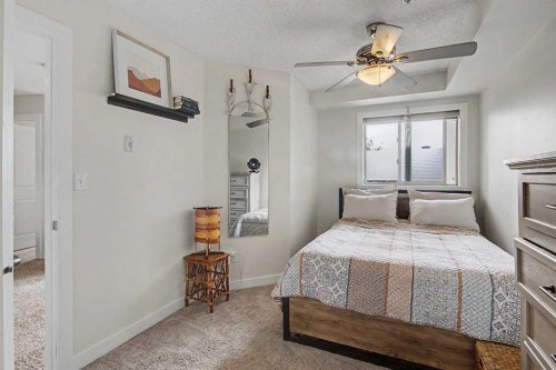 3407-403 Mackenzie Way Sw, Airdrie, AB - Indoor Photo Showing Bedroom