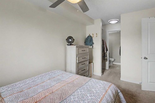 3407-403 Mackenzie Way Sw, Airdrie, AB - Indoor Photo Showing Bedroom