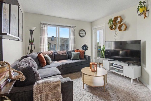 3407-403 Mackenzie Way Sw, Airdrie, AB - Indoor Photo Showing Living Room