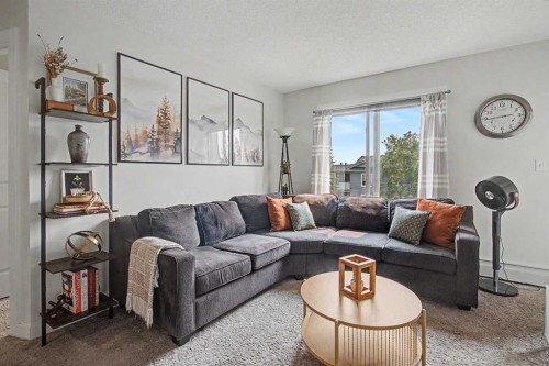 3407-403 Mackenzie Way Sw, Airdrie, AB - Indoor Photo Showing Living Room