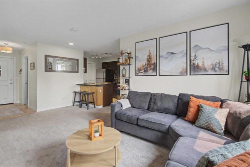 3407-403 Mackenzie Way Sw, Airdrie, AB - Indoor Photo Showing Living Room