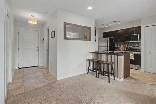 3407-403 Mackenzie Way Sw, Airdrie, AB - Indoor Photo Showing Kitchen