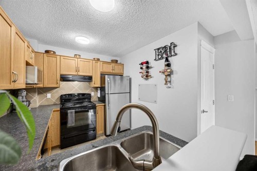 211 Bayside Point Sw, Airdrie, AB - Indoor Photo Showing Kitchen With Double Sink