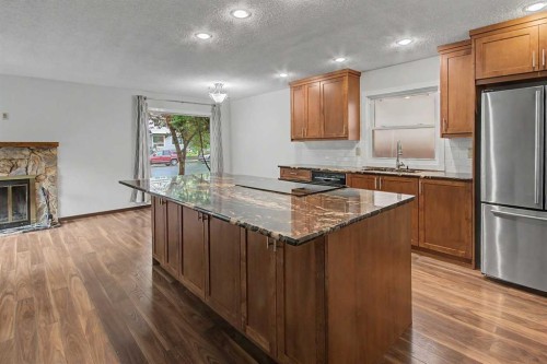115 Mckenna Crescent Se, Calgary, AB - Indoor Photo Showing Kitchen With Fireplace