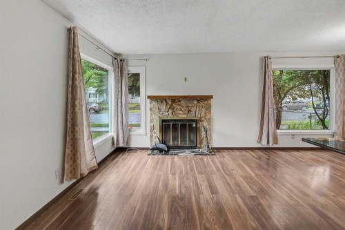 115 Mckenna Crescent Se, Calgary, AB - Indoor Photo Showing Living Room With Fireplace