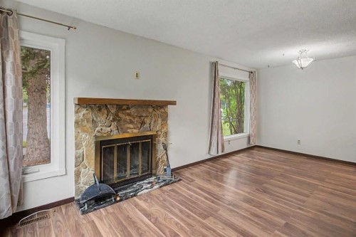 115 Mckenna Crescent Se, Calgary, AB - Indoor Photo Showing Living Room With Fireplace