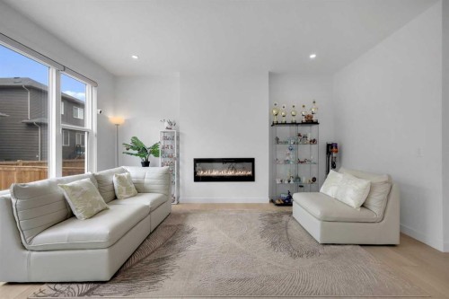 89 Amblehurst Gardens Nw, Calgary, AB - Indoor Photo Showing Living Room With Fireplace