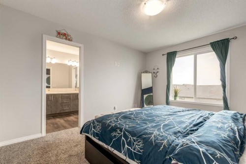 497 Hillcrest Road Sw, Airdrie, AB - Indoor Photo Showing Bedroom