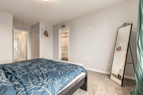 497 Hillcrest Road Sw, Airdrie, AB - Indoor Photo Showing Bedroom
