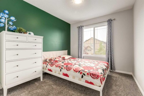 497 Hillcrest Road Sw, Airdrie, AB - Indoor Photo Showing Bedroom