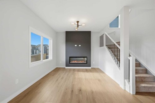 42 Waterford Mews, Chestermere, AB - Indoor Photo Showing Other Room With Fireplace