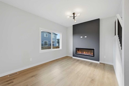42 Waterford Mews, Chestermere, AB - Indoor Photo Showing Living Room With Fireplace