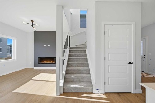 42 Waterford Mews, Chestermere, AB - Indoor Photo Showing Other Room With Fireplace