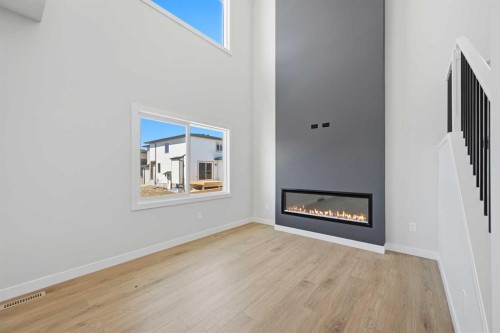 46 Waterford Mews, Chestermere, AB - Indoor Photo Showing Other Room With Fireplace