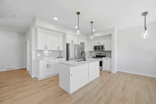 46 Waterford Mews, Chestermere, AB - Indoor Photo Showing Kitchen With Upgraded Kitchen
