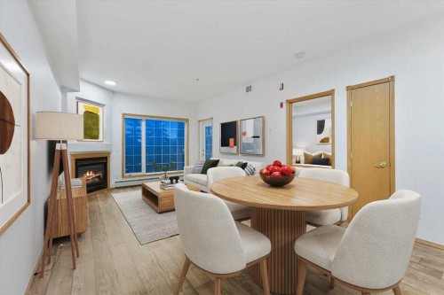 202-4512 52 Avenue, Red Deer, AB - Indoor Photo Showing Dining Room With Fireplace