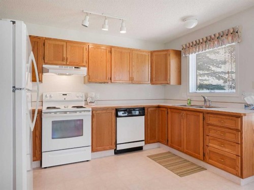 277 Arbour Cliff Close Nw, Calgary, AB - Indoor Photo Showing Kitchen With Double Sink