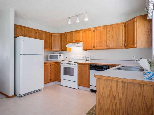 277 Arbour Cliff Close Nw, Calgary, AB - Indoor Photo Showing Kitchen With Double Sink