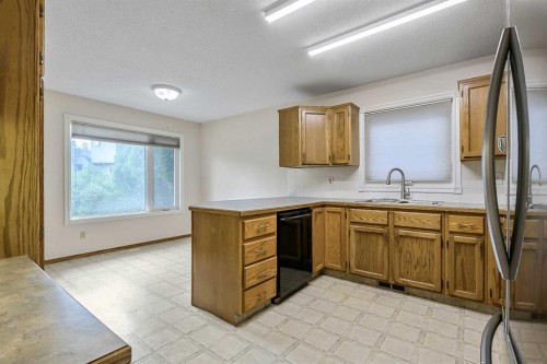 25 Downey Road, Okotoks, AB - Indoor Photo Showing Kitchen With Double Sink