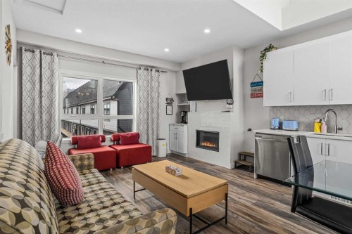 207-105 Kananaskis Way, Canmore, AB - Indoor Photo Showing Living Room With Fireplace