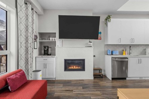 207-105 Kananaskis Way, Canmore, AB - Indoor Photo Showing Living Room With Fireplace