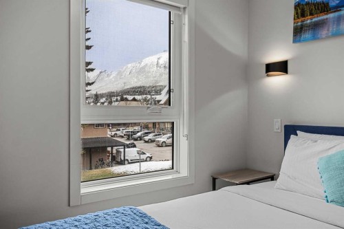 207-105 Kananaskis Way, Canmore, AB - Indoor Photo Showing Bedroom