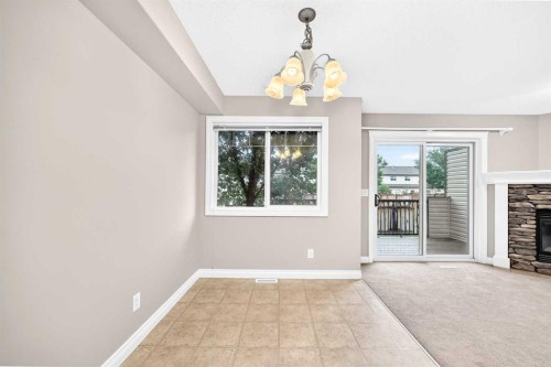 129-308 11 Avenue, High River, AB - Indoor Photo Showing Other Room With Fireplace