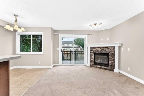 129-308 11 Avenue, High River, AB - Indoor Photo Showing Living Room With Fireplace