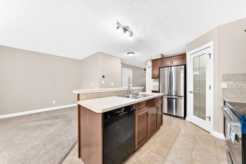 129-308 11 Avenue, High River, AB - Indoor Photo Showing Kitchen With Double Sink