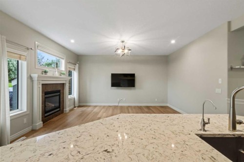 126 Chapman Close Se, Calgary, AB - Indoor Photo Showing Living Room With Fireplace