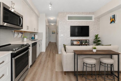 408-20 Walgrove Se, Calgary, AB - Indoor Photo Showing Kitchen With Fireplace With Upgraded Kitchen