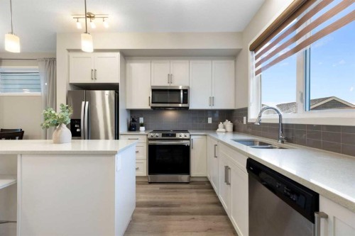 1021 Mahogany Boulevard Se, Calgary, AB - Indoor Photo Showing Kitchen With Double Sink With Upgraded Kitchen