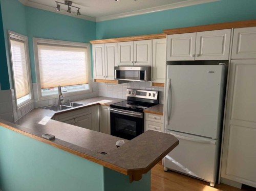101-7 Lineham Avenue, Okotoks, AB - Indoor Photo Showing Kitchen With Double Sink
