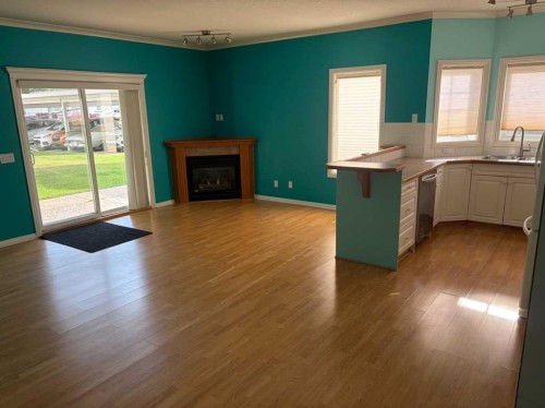 101-7 Lineham Avenue, Okotoks, AB - Indoor Photo Showing Living Room With Fireplace
