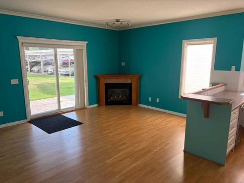 101-7 Lineham Avenue, Okotoks, AB - Indoor Photo Showing Living Room With Fireplace