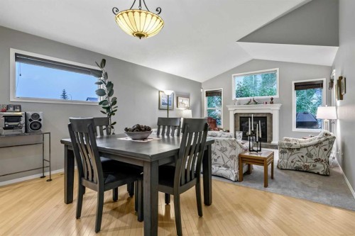416 Silverado Range Heights Sw, Calgary, AB - Indoor Photo Showing Dining Room With Fireplace